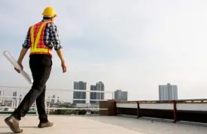 Commercial roofing contractor inspecting roof damage in Southeast US