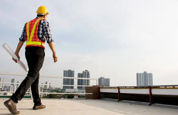 Commercial roofing contractor inspecting roof damage in Southeast US